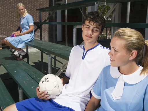 Teenagers sitting on bleachers, one feeling envious of others